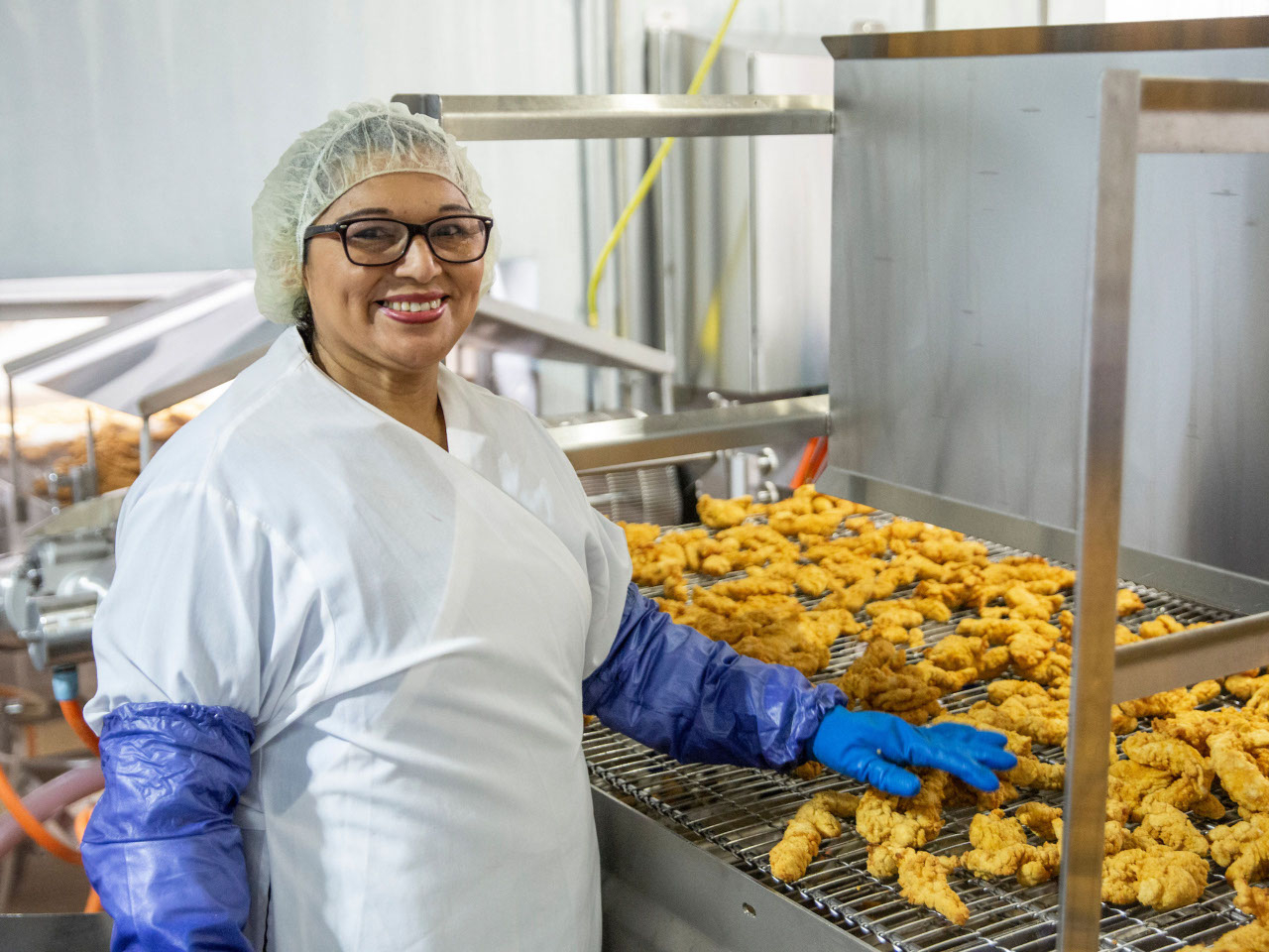 This is a production worker smiling for a photo.